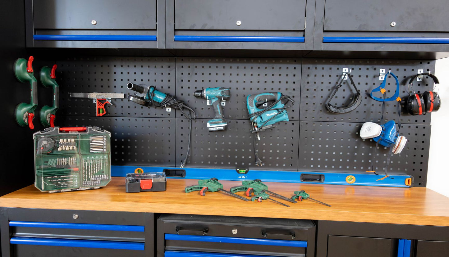 Spacious van conversion workshop in Porto with workbenches, power tools, and storage shelves