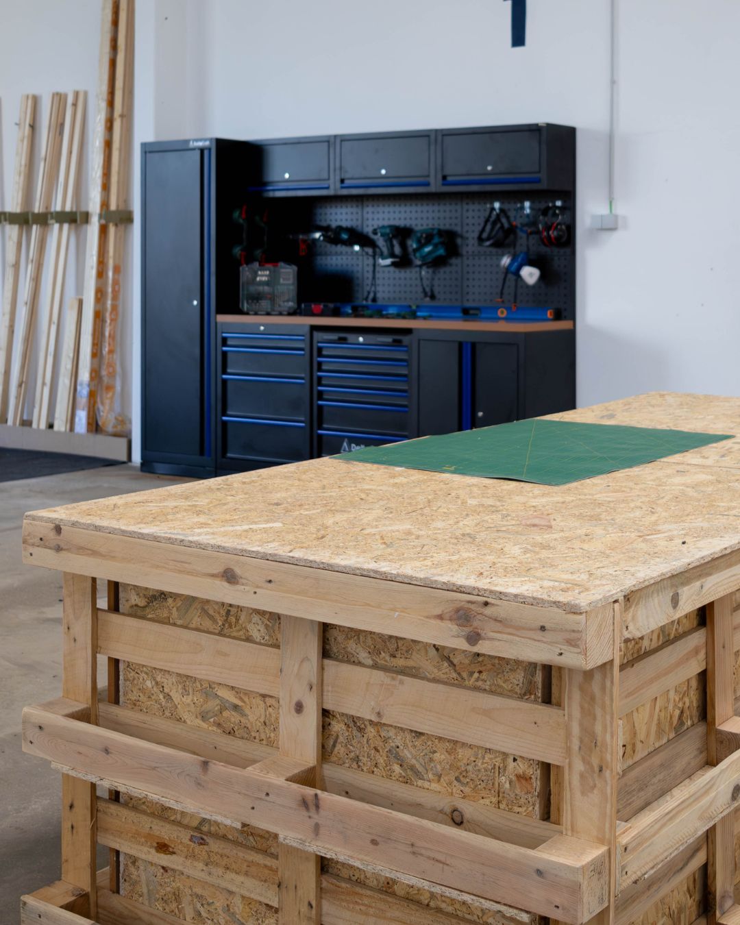 Spacious van conversion workshop in Porto with workbenches, power tools, and storage shelves