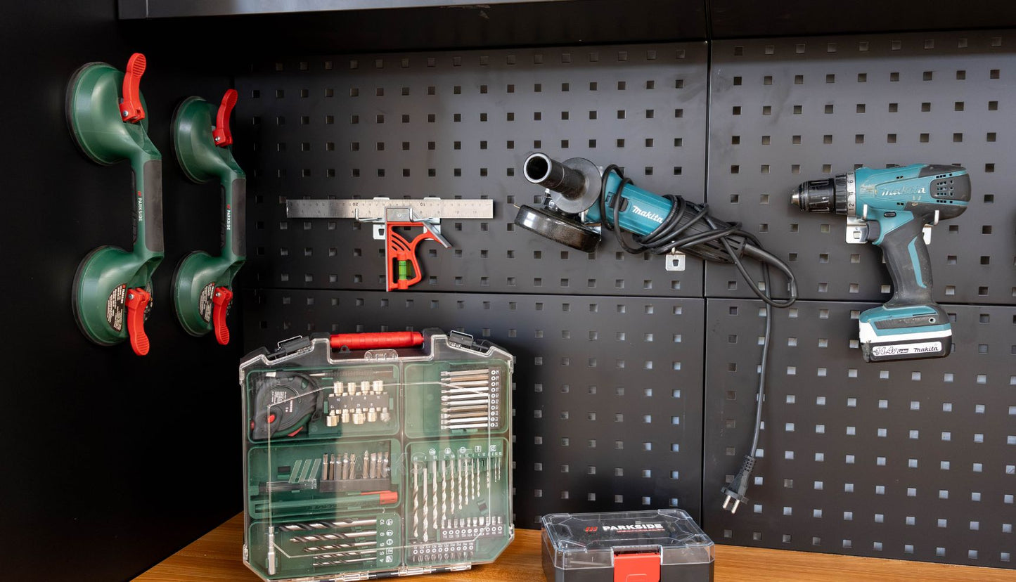 Spacious van conversion workshop in Porto with workbenches, power tools, and storage shelves
