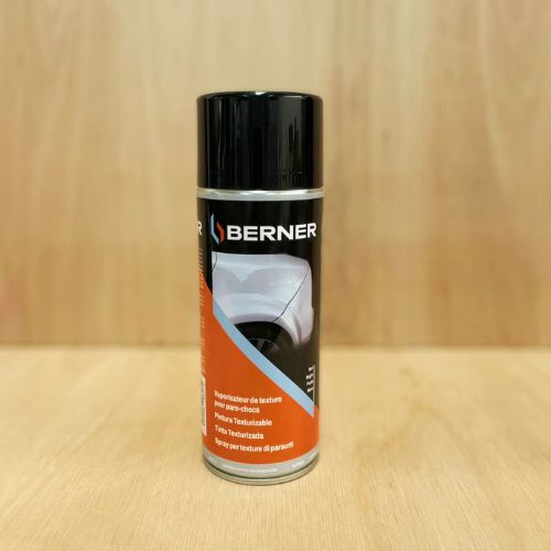 Applying black bumper spray to a van’s faded plastic trim