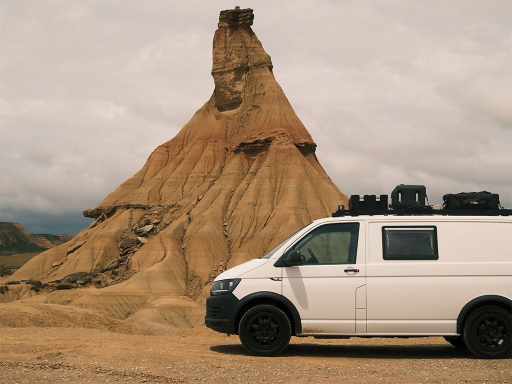 Slimsport rack fitted with accessories such as roof box and solar panels on Volkswagen Transporter SWB.